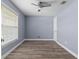 Light blue bedroom features a ceiling fan, window, and wood flooring at 404 N Sundance Dr, Lake Mary, FL 32746