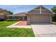 Charming single-story home with a well-manicured lawn and a two-car garage at 404 N Sundance Dr, Lake Mary, FL 32746