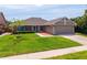 Lovely home featuring a brick accent wall, a manicured lawn, and an attached two-car garage at 404 N Sundance Dr, Lake Mary, FL 32746