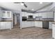 Modern kitchen featuring stainless steel appliances, granite countertops, and white cabinetry at 404 N Sundance Dr, Lake Mary, FL 32746