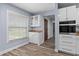 Bright kitchen features wood floors, white cabinets, and a window for natural light at 404 N Sundance Dr, Lake Mary, FL 32746