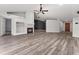 Bright living room features vaulted ceiling, ceiling fan, wood flooring, and fireplace at 404 N Sundance Dr, Lake Mary, FL 32746