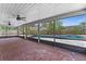 Covered patio boasts brick floors, ceiling fans, and views of the fenced backyard and pool at 404 N Sundance Dr, Lake Mary, FL 32746