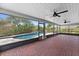 Covered patio with ceiling fans, brick floors offers a view of the pool and fenced backyard at 404 N Sundance Dr, Lake Mary, FL 32746
