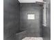 Modern tiled shower with a rainfall showerhead, handheld sprayer, and built-in niche at 404 N Sundance Dr, Lake Mary, FL 32746