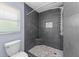 Modern tile shower featuring a rainfall showerhead, handheld sprayer and mosaic tile floor at 404 N Sundance Dr, Lake Mary, FL 32746