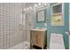 Modern bathroom featuring a glass shower with decorative tile, a rustic vanity, and an updated sink at 407 S Lakemont Ave, Winter Park, FL 32792