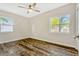 Light-filled bedroom with wood floors, ceiling fan, and two windows offering natural light at 407 S Lakemont Ave, Winter Park, FL 32792