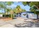 Exterior view of a home showcasing an attached one-car garage and manicured shrubs at 407 S Lakemont Ave, Winter Park, FL 32792