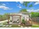 Backyard patio area featuring outdoor seating, a pergola, and a staircase at 415 Florida Ave, St Cloud, FL 34769