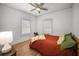 Comfortable bedroom with hardwood floors, neutral walls, and natural light from windows at 415 Florida Ave, St Cloud, FL 34769
