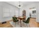 Airy dining room with mid-century modern accents, area rug, and a view into the kitchen at 415 Florida Ave, St Cloud, FL 34769