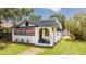 Charming vintage bungalow with American flag, front porch, and landscaped yard at 415 Florida Ave, St Cloud, FL 34769
