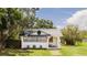 Charming single-story home with a quaint front porch, fresh landscaping, and an American flag at 415 Florida Ave, St Cloud, FL 34769