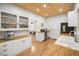 Bright kitchen featuring butcher block countertops, wooden ceiling, white cabinetry, and stainless steel appliances at 415 Florida Ave, St Cloud, FL 34769