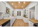 Bright kitchen with butcher block countertops, wooden ceiling, white cabinets and appliances, and a farmhouse sink at 415 Florida Ave, St Cloud, FL 34769