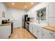 Well-lit kitchen with white cabinetry, stainless steel appliances, and butcher block countertops at 415 Florida Ave, St Cloud, FL 34769