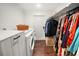 Laundry room with white washer and dryer, folding counter, hanging rack, and hardwood floors at 415 Florida Ave, St Cloud, FL 34769