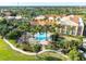 Aerial view of community showcasing lush landscaping, pool, and multiple buildings at 433 Via Abruzzi St, Kissimmee, FL 34759