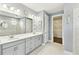 Bathroom features double vanity, large mirror, and walk-in shower at 433 Via Abruzzi St, Kissimmee, FL 34759