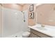 Light pink bathroom with tiled walk-in shower, a framed print, and a vanity with sink and mirror at 433 Via Abruzzi St, Kissimmee, FL 34759