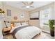 Nicely staged bedroom with neutral walls, white bedding, and lots of natural light from the window at 433 Via Abruzzi St, Kissimmee, FL 34759