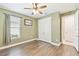Bedroom with green walls, hardwood floors, white trim, a ceiling fan, closet, and connecting bathroom at 433 Via Abruzzi St, Kissimmee, FL 34759