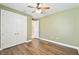 Comfortable bedroom features wood-look floors, ceiling fan and large closet at 433 Via Abruzzi St, Kissimmee, FL 34759