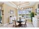 Elegant dining area with water views, glass table, and seating for four at 433 Via Abruzzi St, Kissimmee, FL 34759