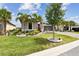 Beautifully landscaped front yard with palm trees and lush green grass at 433 Via Abruzzi St, Kissimmee, FL 34759