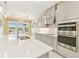 Modern kitchen features stainless steel appliances, quartz countertops, and gray cabinetry at 433 Via Abruzzi St, Kissimmee, FL 34759