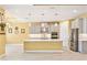 Open-concept kitchen with stainless steel appliances and a large central island at 433 Via Abruzzi St, Kissimmee, FL 34759