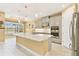 Well-appointed kitchen with quartz countertops, gray cabinetry, and stainless-steel refrigerator at 433 Via Abruzzi St, Kissimmee, FL 34759