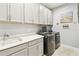 Convenient laundry room with front-load washer/dryer and lots of storage at 433 Via Abruzzi St, Kissimmee, FL 34759