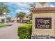 Inviting Village Center sign with well-maintained street, shops and landscaped surroundings creating a welcoming community at 433 Via Abruzzi St, Kissimmee, FL 34759