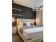 Beautiful bedroom showcasing a panel accent wall with unique lighting fixtures at 4473 Kaipo Rd, Davenport, FL 33897