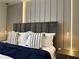 Modern bedroom emphasizing chic wall decor and fashionable pendant bedside lamps at 4473 Kaipo Rd, Davenport, FL 33897