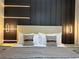 Comfortable bedroom featuring a contemporary bed frame and a sleek, paneled accent wall at 4473 Kaipo Rd, Davenport, FL 33897