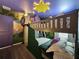 Custom-designed bedroom with stone accents, bunk beds, murals, and decorative details at 4473 Kaipo Rd, Davenport, FL 33897