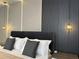 Chic bedroom boasting modern wall accents, stylish bedside lighting, and minimalist decor at 4473 Kaipo Rd, Davenport, FL 33897