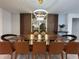 Dining room boasts a modern table with leather chairs, chic lighting, and elegant decor, creating a perfect dining space at 4473 Kaipo Rd, Davenport, FL 33897