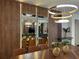 Dining area featuring a large wood table, seating, decorative mirrors and modern light fixtures at 4473 Kaipo Rd, Davenport, FL 33897