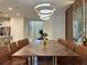 Dining room with a long, elegant table, seating for twelve, and modern lighting at 4473 Kaipo Rd, Davenport, FL 33897