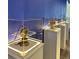 Artifacts are displayed along the blue wall inside light-up glass cases on pedestals at 4473 Kaipo Rd, Davenport, FL 33897
