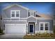 Charming two-story home with a well-manicured lawn and attached two-car garage at 4473 Kaipo Rd, Davenport, FL 33897