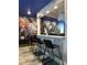 A close up of the game room bar area with barstools and a Marvel-themed mural at 4473 Kaipo Rd, Davenport, FL 33897
