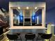 Game room bar featuring seating, a sleek gray countertop, and a view into the theater room at 4473 Kaipo Rd, Davenport, FL 33897