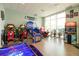 Bright community game room featuring a variety of arcade games and a large window at 4473 Kaipo Rd, Davenport, FL 33897