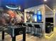 Entertaining game room featuring bar seating, fun Marvel-themed mural, and a foosball table at 4473 Kaipo Rd, Davenport, FL 33897