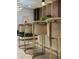 Eye-level perspective on gold-trimmed kitchen bar stools next to white bar with tile flooring and recessed lighting at 4473 Kaipo Rd, Davenport, FL 33897